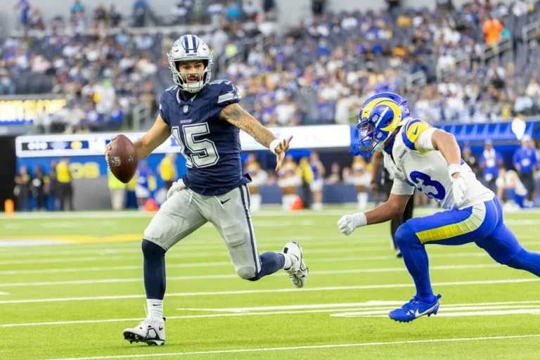 Cowboys quarterback Will Grier #15 runs Rams safety Nate Valcarcel #43 to score a touchdown during an NFL preseason football game at SoFi Stadium, Saturday Aug. 9, 2025, in Inglewood, Calif.
